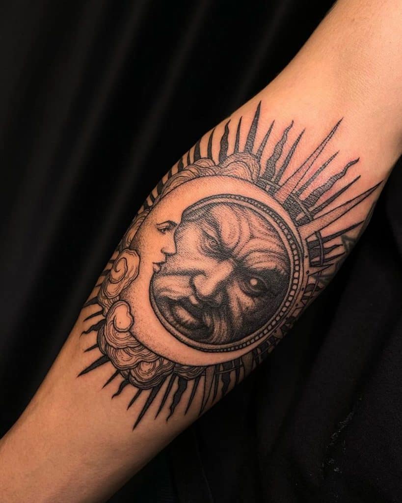 Black ink tattoo of an intense sun and serene moon, featuring intricate shading, bold rays, and a detailed celestial design on the forearm.
