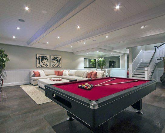 classy basement living room white sofa red billiards table 