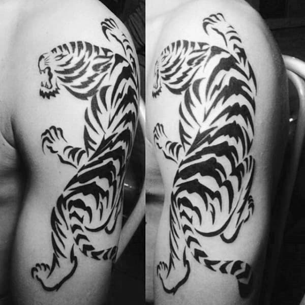Black and white tiger tattoo on an upper arm