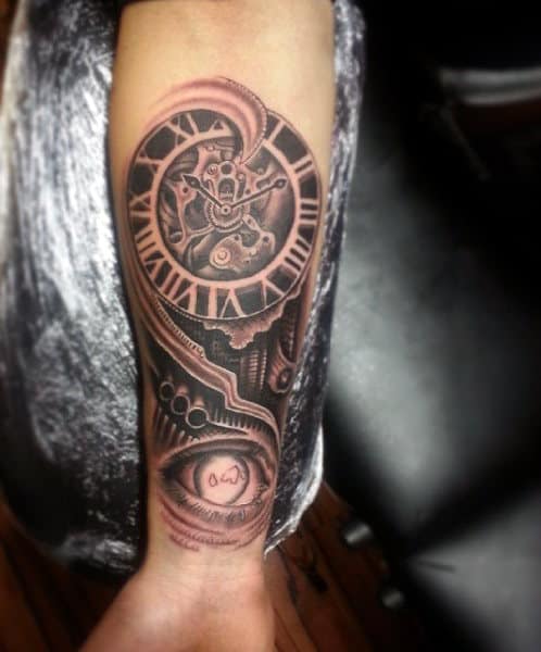 Wrist tattoo featuring a steampunk-inspired clock design with gears and an eye
