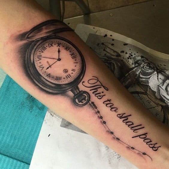 A beautifully detailed "This too shall pass" tattoo featuring a realistic pocket watch, symbolizing the passage of time and the impermanence of life.