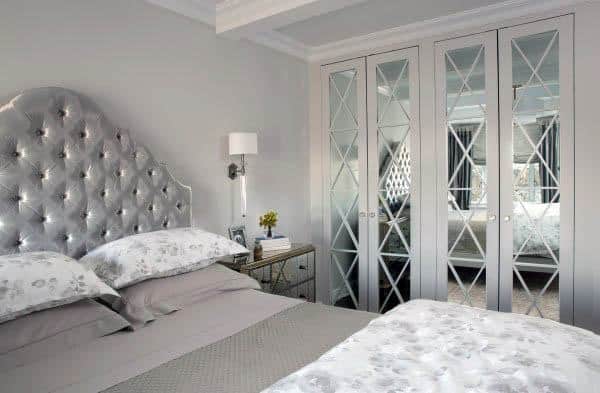 A chic bedroom with mirrored closet doors featuring diamond-patterned panels, adding elegance and style to the room