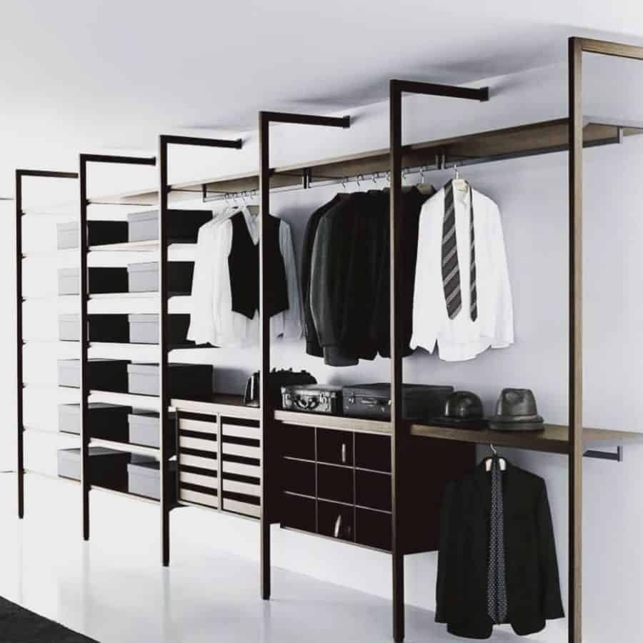 Men's minimalist wardrobe with open shelving and organized clothing storage.