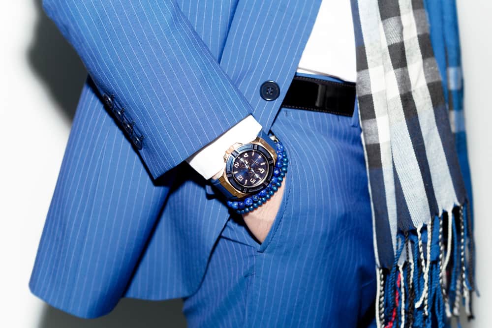 closeup fashion of man wearing blue suit with watch on wrist