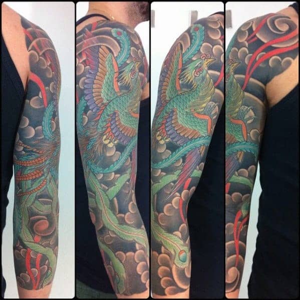 Japanese-style half-sleeve tattoo featuring a vibrant phoenix in flight, surrounded by clouds and dynamic red accents