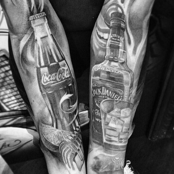 Black and grey Coca-Cola and Jack Daniel's bottle tattoos with intricate shading, ice cubes, and a lime slice for a bold, classic look.