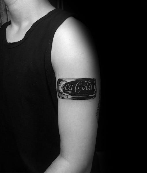 Bold Coca-Cola can armband tattoo in black and grey, wrapping around the upper arm with detailed shading for a striking design.