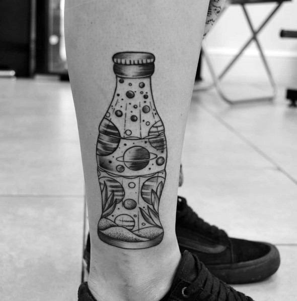 Black and grey Coca-Cola bottle tattoo with a surreal cosmic design, featuring planets, stars, and abstract elements for a unique artistic look.