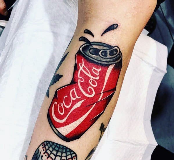 Bold Coca-Cola can tattoo featuring a crushed design with splashing details, vibrant red tones, and dynamic shading for a striking look.