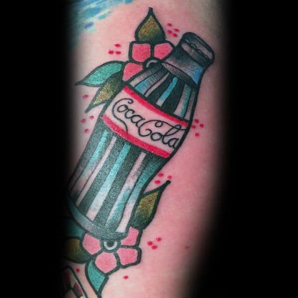 Traditional-style Coca-Cola bottle tattoo with bold outlines, vibrant colors, and floral accents for a classic and timeless design.