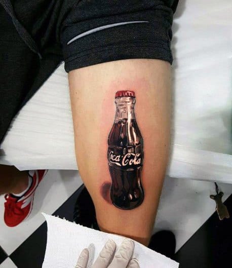 Hyper-realistic Coca-Cola bottle tattoo with detailed reflections, shading, and a 3D effect, creating a lifelike and glossy appearance on the skin.