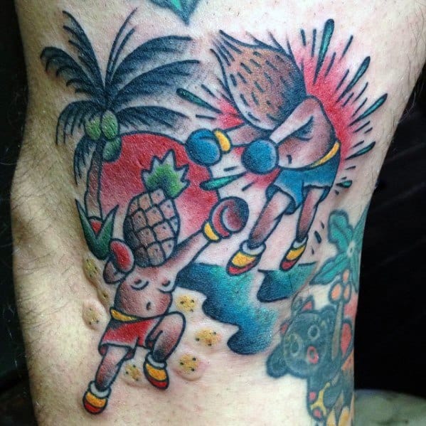 Vibrant cartoon-style tattoo of a boxing match between a pineapple and coconut character under a palm tree with a red sun backdrop.