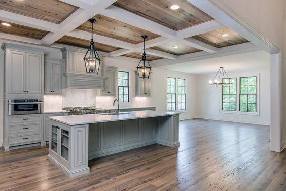 Bright kitchen with coffered wood ceiling, pendant lighting, and spacious island design.