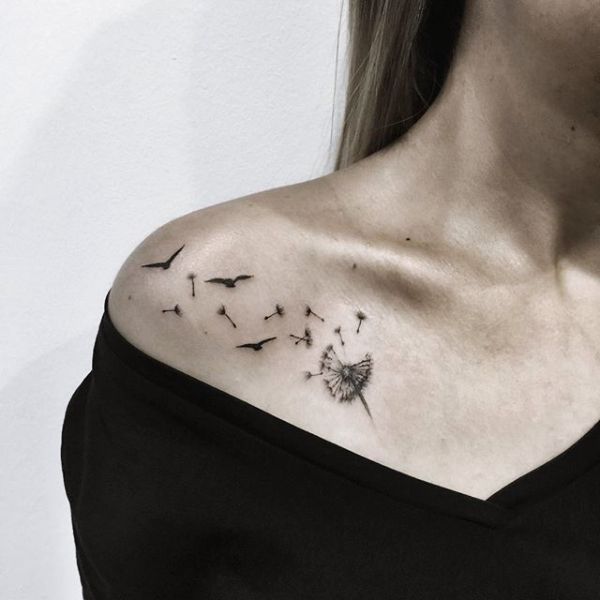 This tattoo features a dandelion with seeds transforming into birds, symbolizing freedom and transformation across the shoulder.