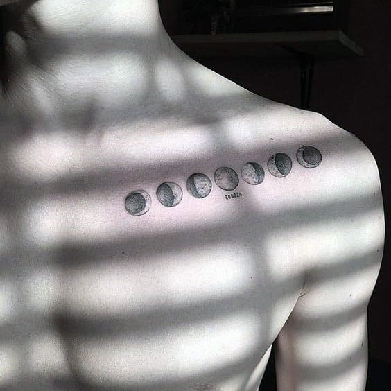 A tattoo of moon phases on a collarbone, with sunlight casting striped shadows