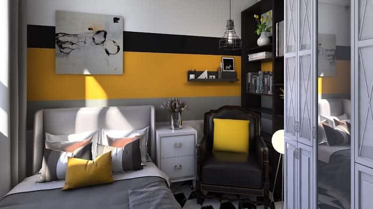 Modern college dorm bedroom with yellow and black accents, cozy seating, and bookshelf.