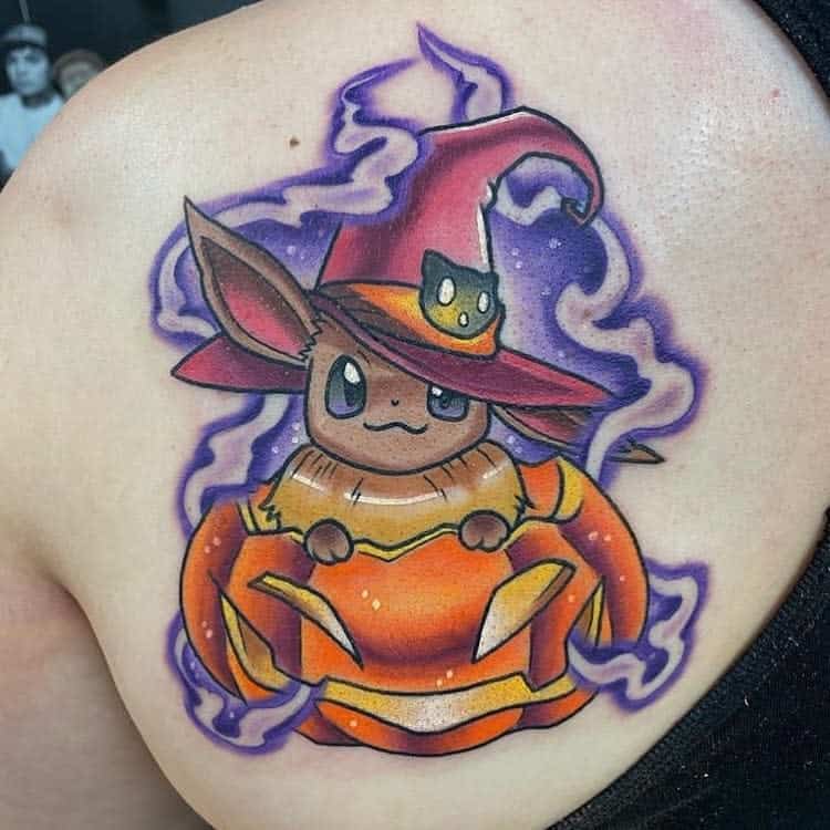 Magical Eevee tattoo dressed as a witch inside a glowing pumpkin, surrounded by purple mystical energy for a spooky-cute vibe