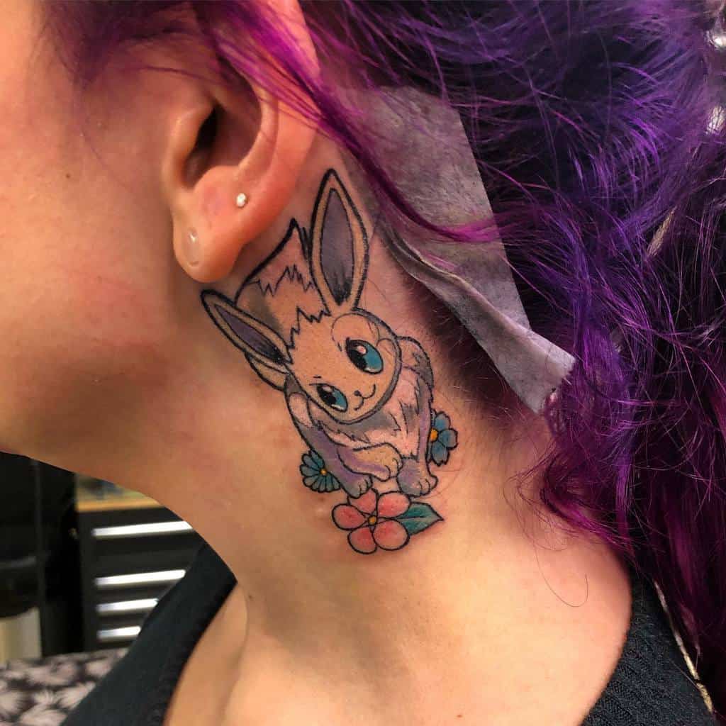 Colorful Eevee tattoo on neck with floral accents, showcasing vibrant purple hair and playful design
