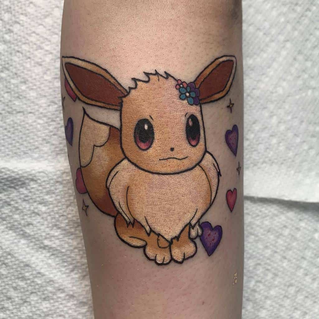 Adorable Eevee tattoo with a flower crown and colorful hearts, adding a cute and whimsical touch to the design