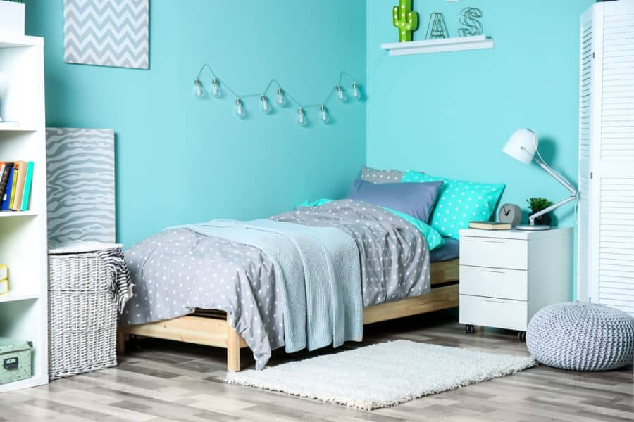 blue wall bedroom wood plank bed frame white bedside table