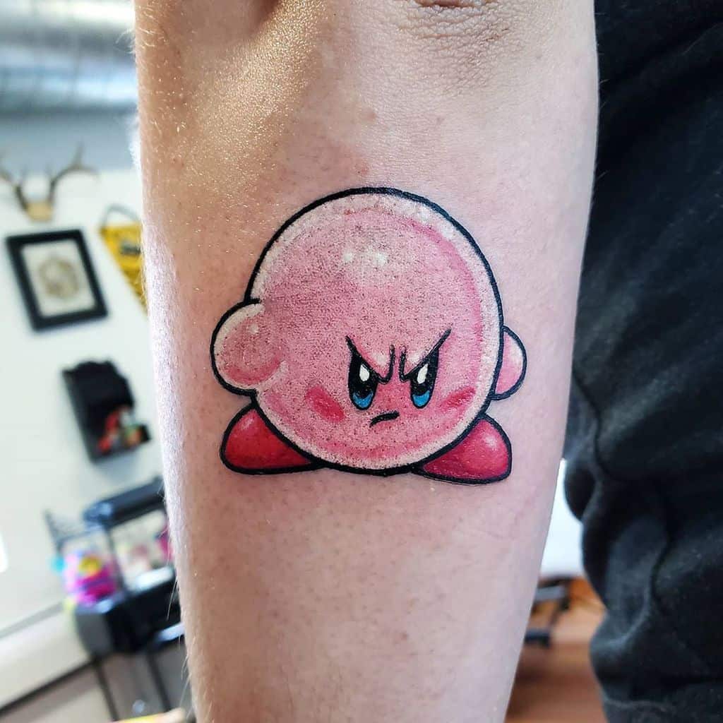 Kirby tattoo with an intense, determined expression, bold outlines and shading give depth to this fierce and dynamic design