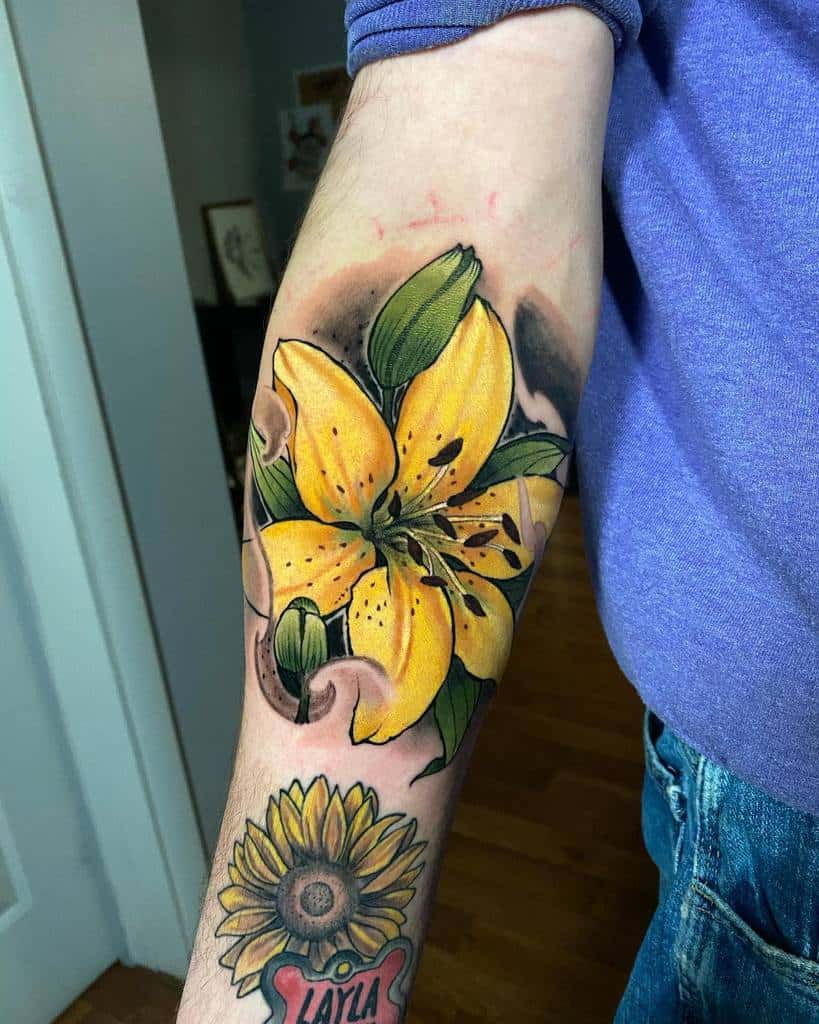 Bold tattoo of a vibrant yellow lily with rich shading and a sunflower below, blending realism and neo-traditional style beautifully