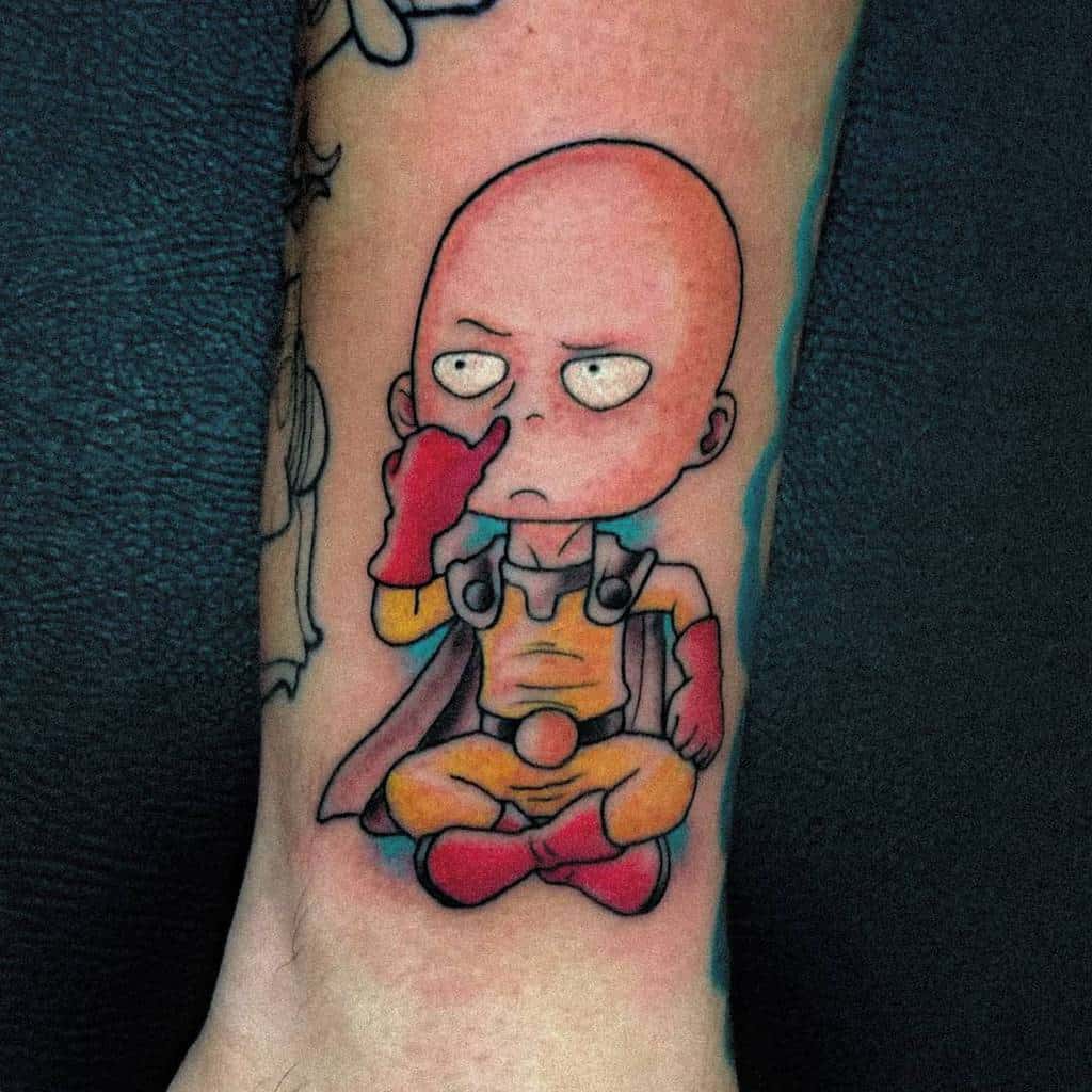 A colorful tattoo of chibi Saitama from One Punch Man sitting down, picking his nose with a bored expression on his face