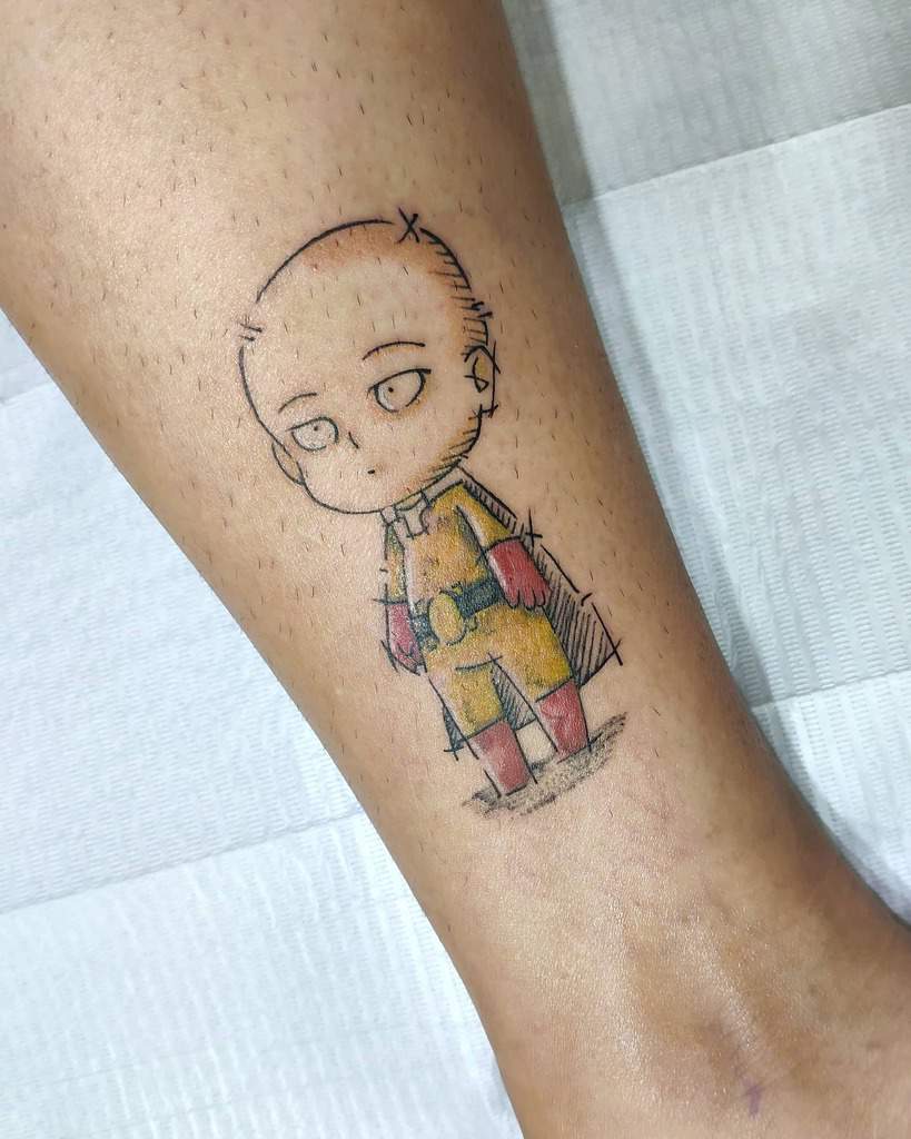 A minimalistic chibi-style tattoo of Saitama from One Punch Man, with a bored expression, wearing his iconic yellow suit and red gloves
