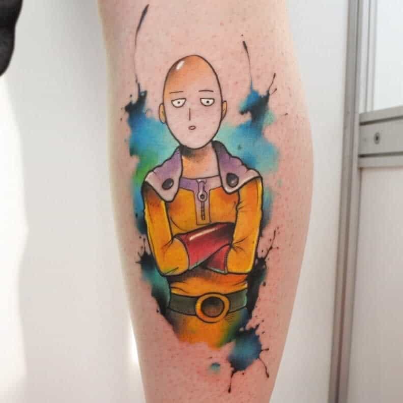 A vibrant watercolor-style tattoo of Saitama from One Punch Man with his signature blank expression, arms crossed, surrounded by splashes of color