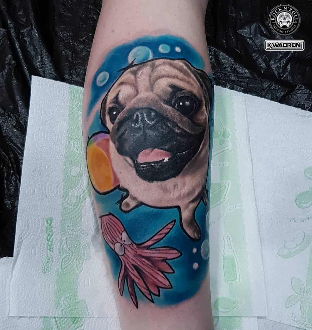 A playful tattoo of a pug swimming underwater with a colorful background of bubbles, a beach ball, and a cartoonish octopus