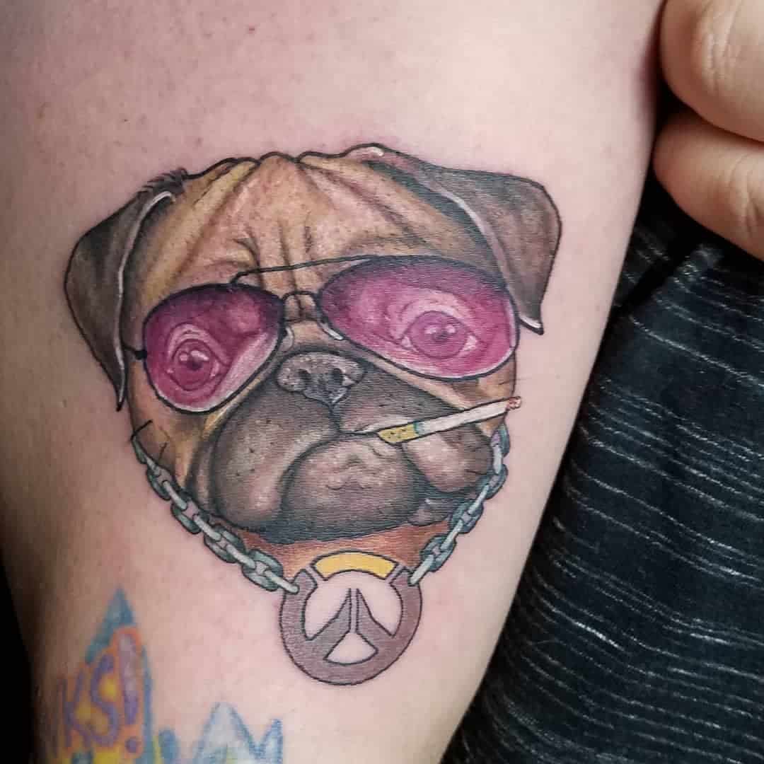 Tattoo of a pug wearing pink sunglasses, a peace sign necklace, and holding a small cigarette stick in its mouth