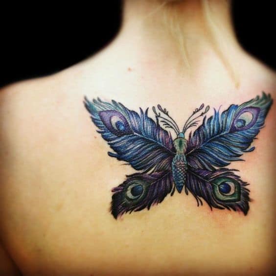 Unique back tattoo of a butterfly with wings designed as peacock feathers, featuring vibrant blue, green, and purple hues with intricate details.