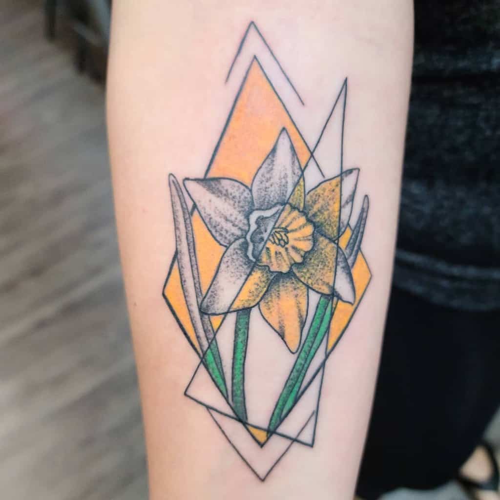 Geometric tattoo of a daffodil with a yellow background on an arm