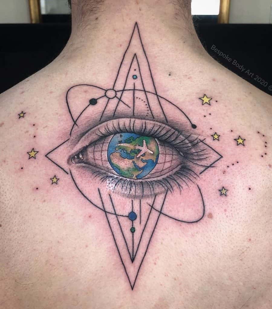 Back tattoo featuring a detailed eye with Earth as its iris, surrounded by geometric and celestial elements, symbolizing cosmic vision and exploration.