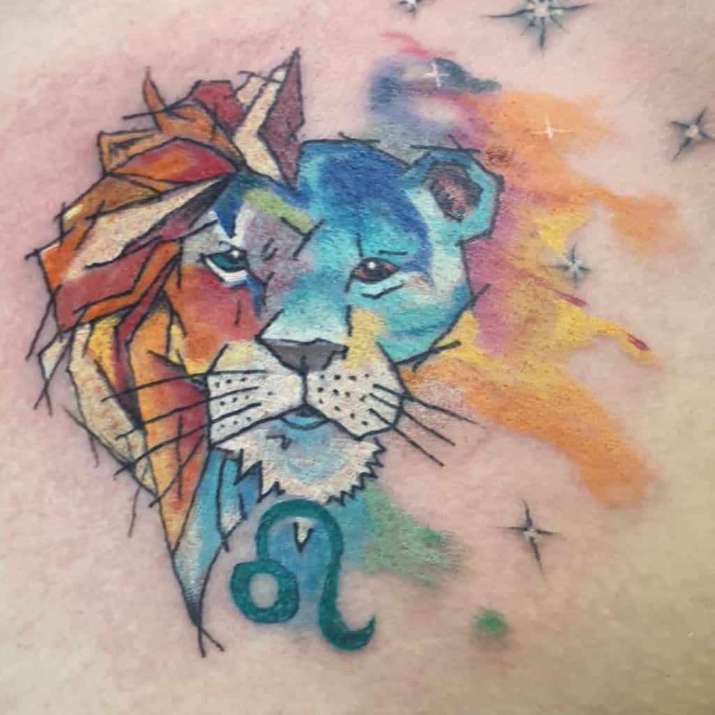 Colorful Leo zodiac tattoo showcasing a lion with fiery and cool tones, symbolizing strength and balance.