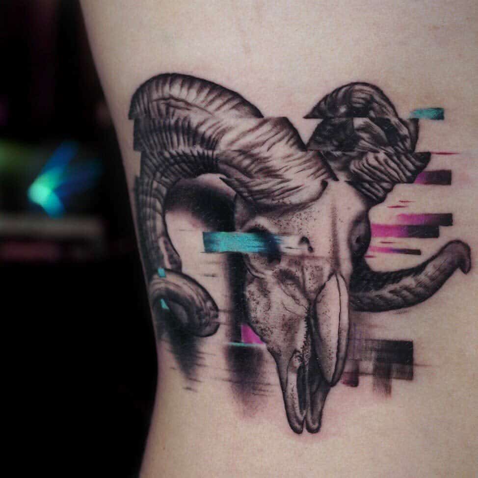 Tattoo of a ram skull intertwined with abstract elements, elegantly inked on the side of a torso