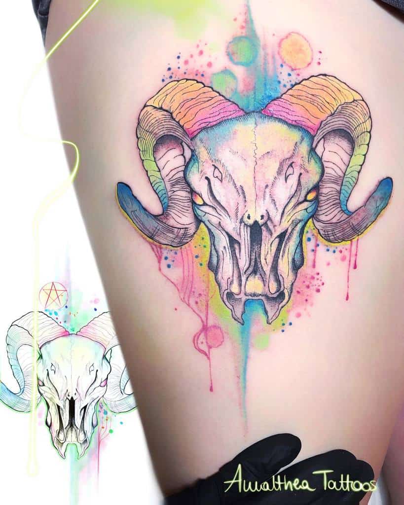 Tattoo of a vibrant ram skull with colorful hues on a thigh