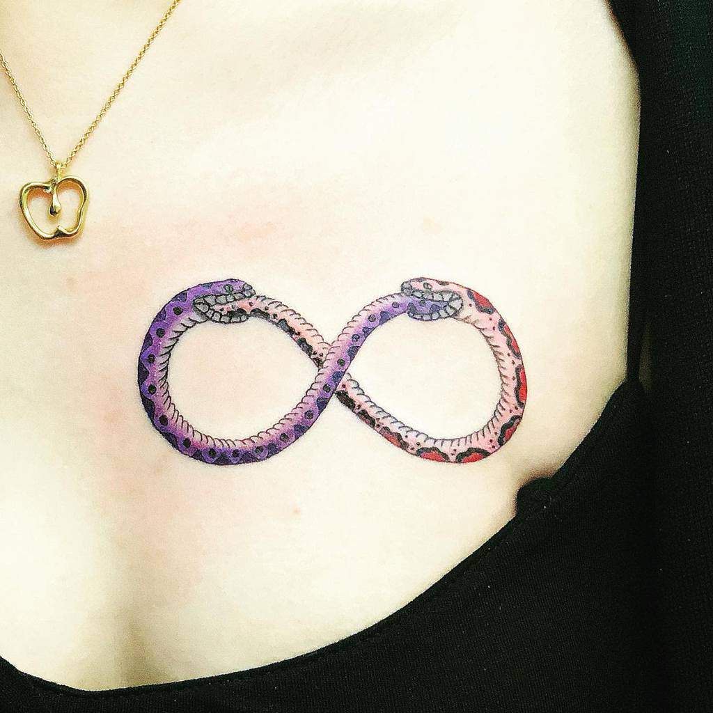 Tattoo of two snakes forming an infinity symbol on a chest