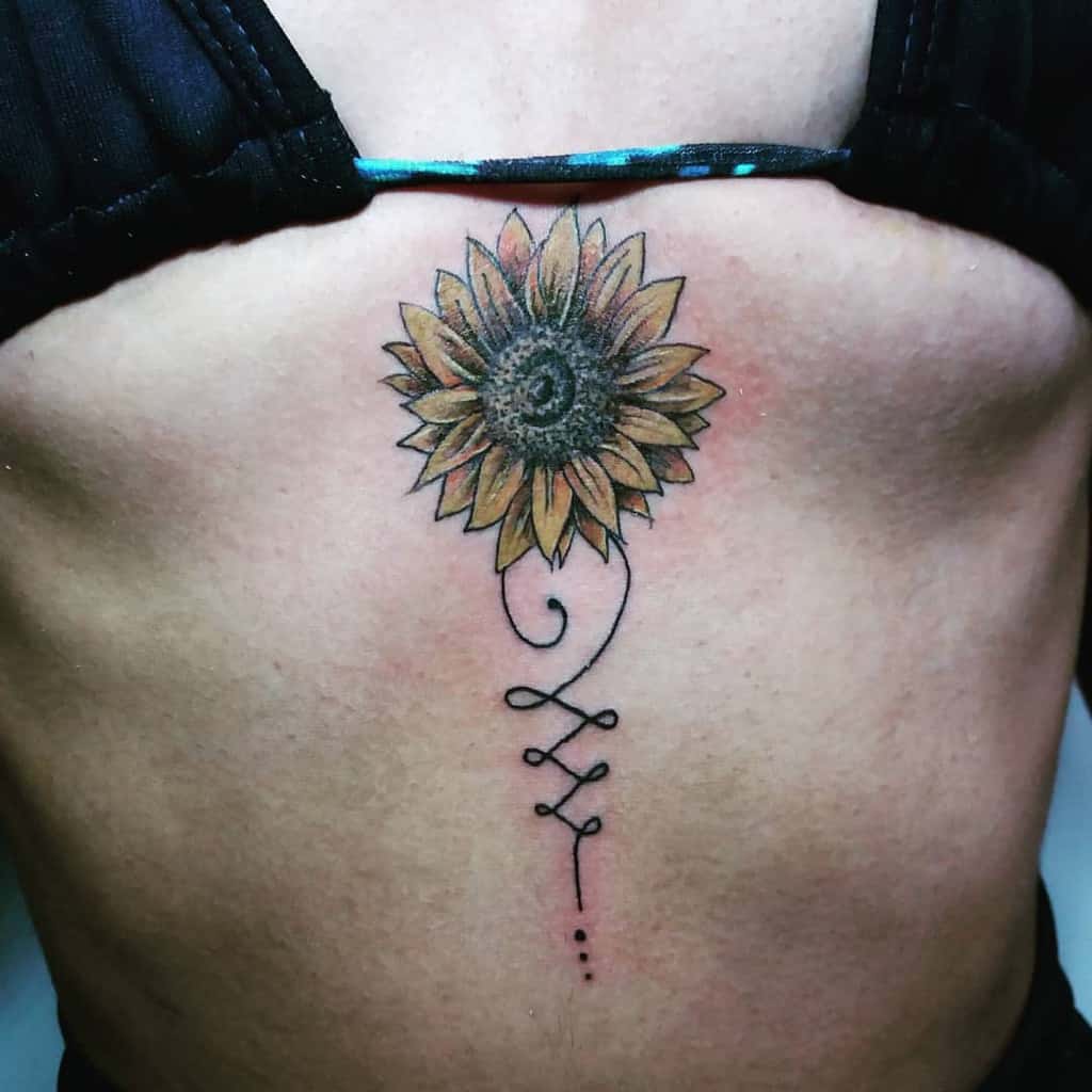 Unalome tattoo with a sunflower on the chest, symbolizing positivity, resilience, and the journey toward enlightenment and personal growth.