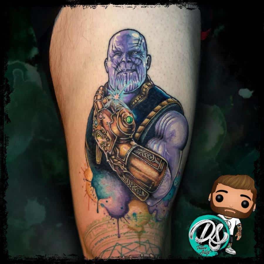 A colorful tattoo of Thanos, showing him holding the gauntlet with the Infinity Stones, surrounded by vibrant watercolor splashes