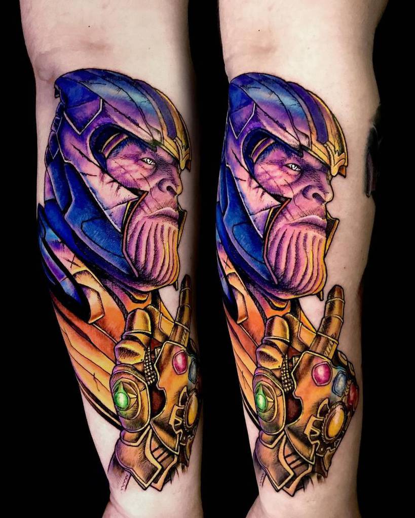A vibrant and colorful tattoo of Thanos, featuring his face in a side profile with a colorful gauntlet and the Infinity Stones