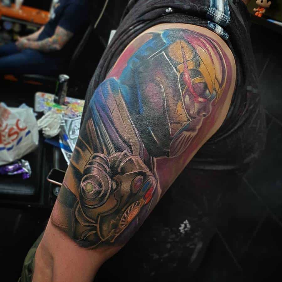 A colorful tattoo of Thanos, showcasing his side profile with vibrant colors on his helmet and gauntlet, featuring the Infinity Stones