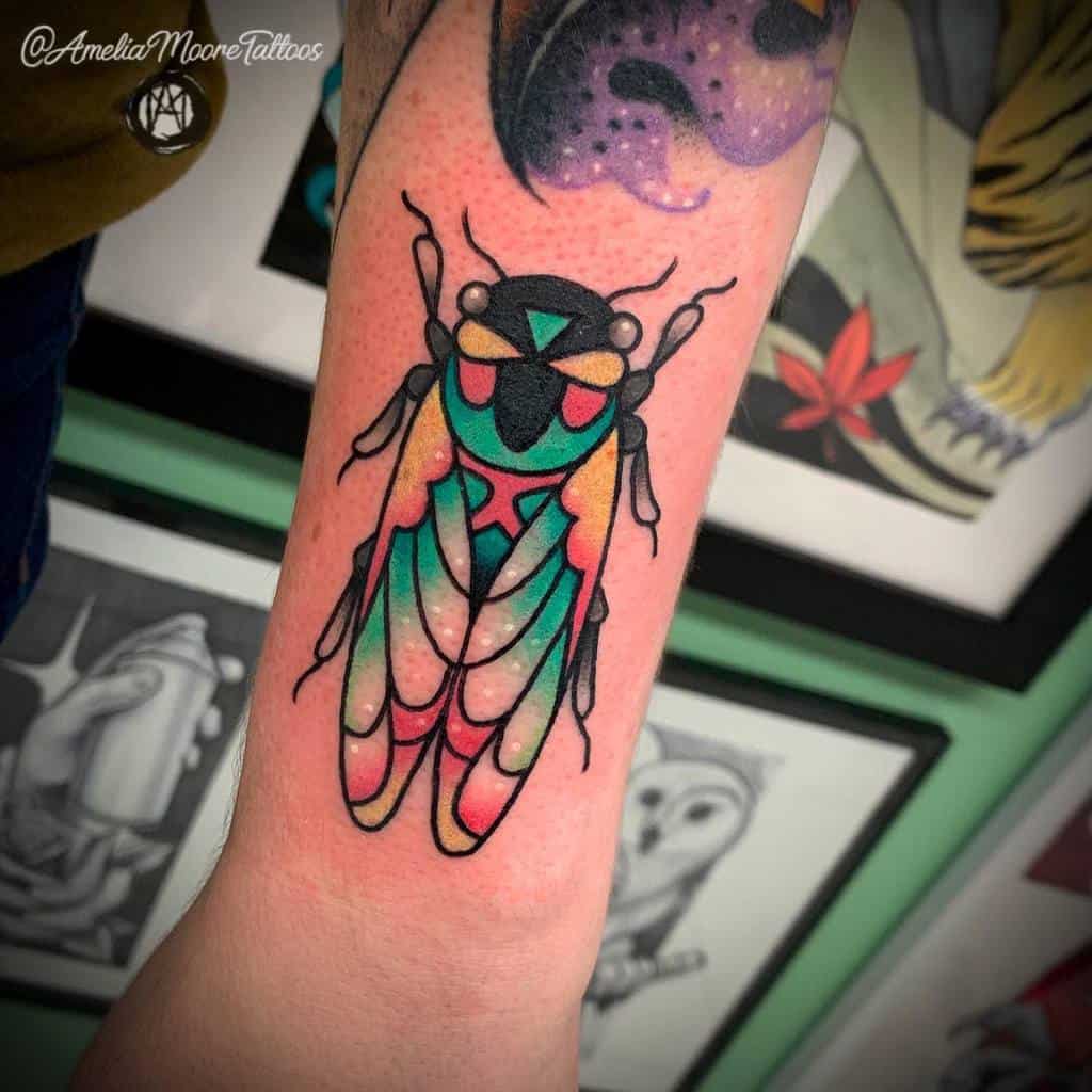 Colorful cicada tattoo on forearm with geometric patterns and a star