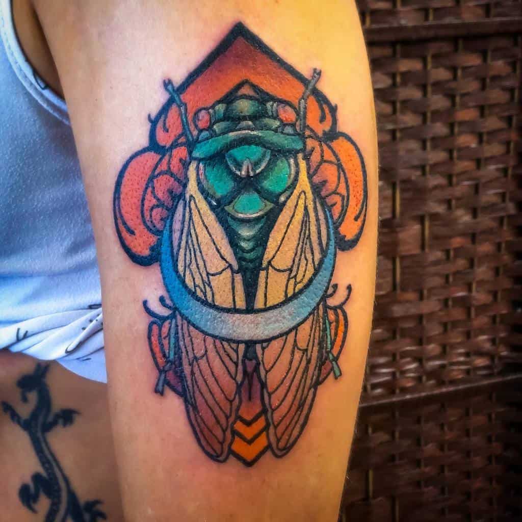 Colorful cicada tattoo on a person's arm with geometric background