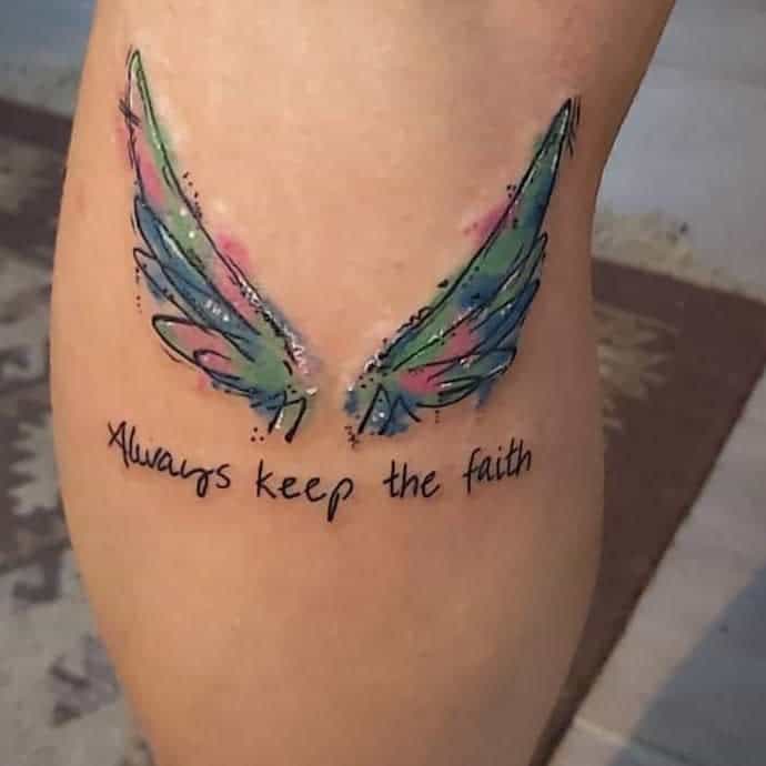 Tattoo of colorful angel wings with the words "Always keep the faith"