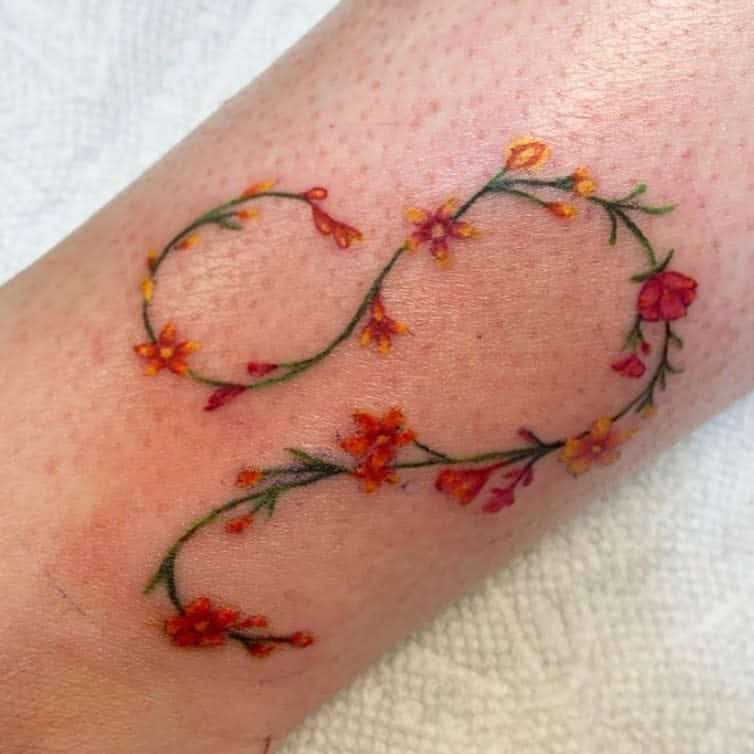 Beautiful Leo sign tattoo with tiny blooming flowers and leaves, adding a graceful and botanical touch.