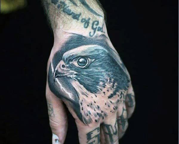 Hand tattoo of a detailed, realistic eagle head
