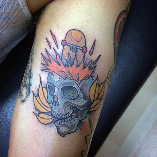 Colorful Blue Skull With Flaming Skateboard Tattoo Design On Arm Of Man