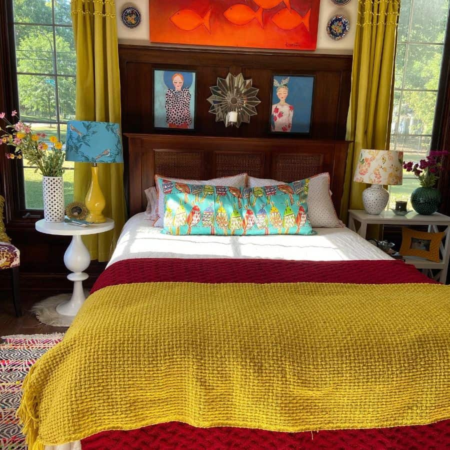 Colorful bedroom with a vibrant bedspread, decorative pillows, bold curtains, and eclectic wall art