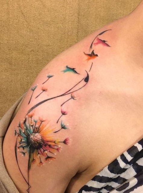 Colorful dandelion tattoo on shoulder with seeds transforming into birds